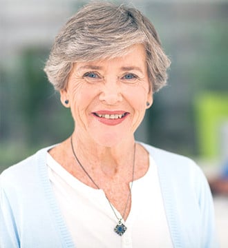 Healthy woman with grey hair smiling